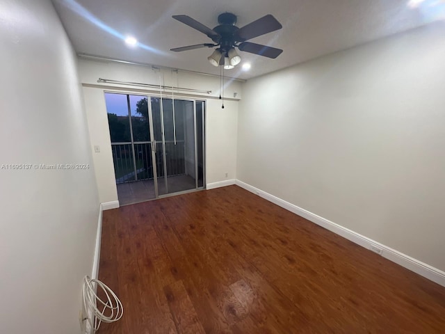 spare room with hardwood / wood-style flooring and ceiling fan