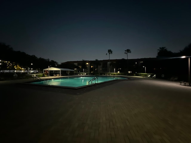 view of pool at night