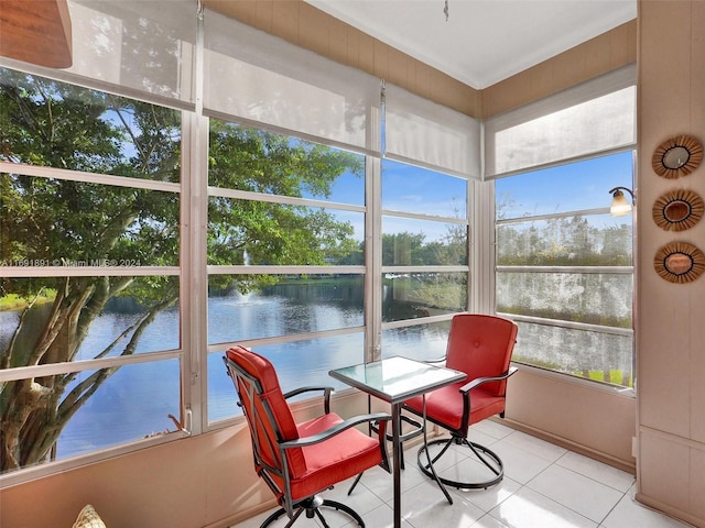 sunroom featuring plenty of natural light and a water view