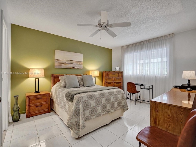 tiled bedroom with a textured ceiling and ceiling fan