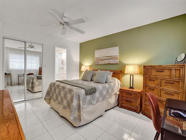 bedroom featuring ceiling fan, light tile patterned flooring, connected bathroom, and a closet