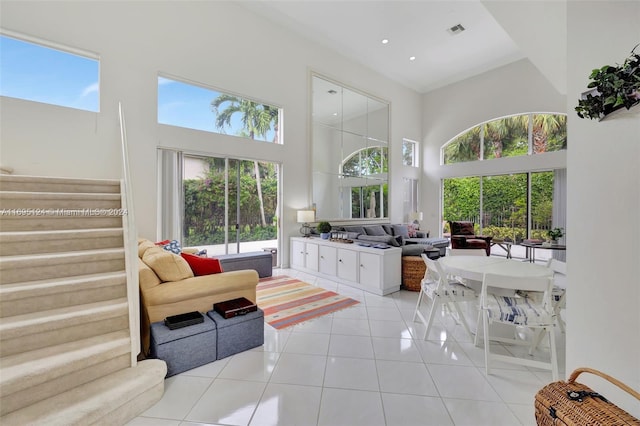 tiled living room with a towering ceiling