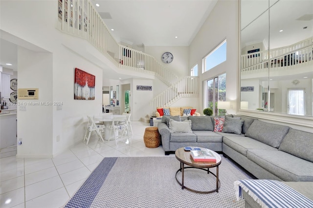 living room featuring light tile patterned flooring and a high ceiling