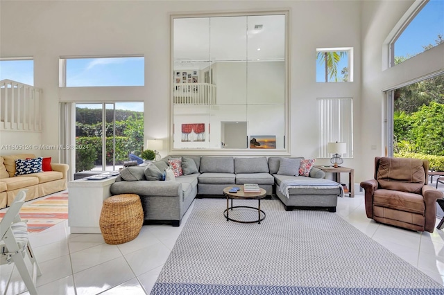 living room with light tile patterned flooring and a high ceiling