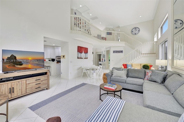 tiled living room featuring a towering ceiling