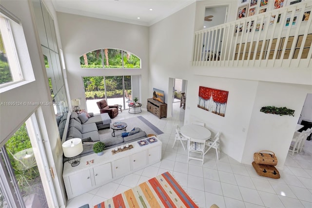 tiled living room featuring crown molding and a high ceiling