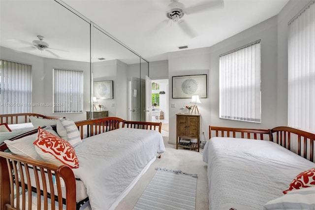 bedroom featuring ceiling fan and carpet