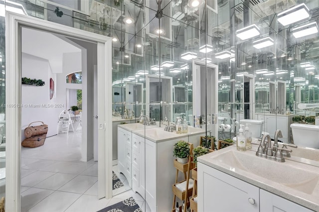 bathroom with tile patterned floors, vanity, and toilet