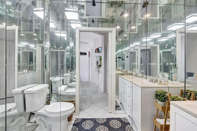 bathroom featuring tile patterned flooring, vanity, and toilet