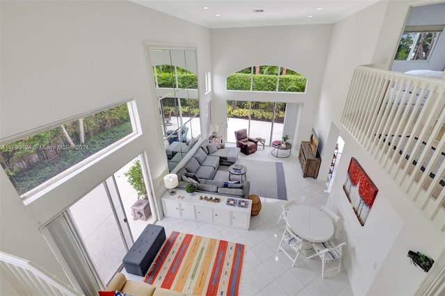 tiled living room with a towering ceiling