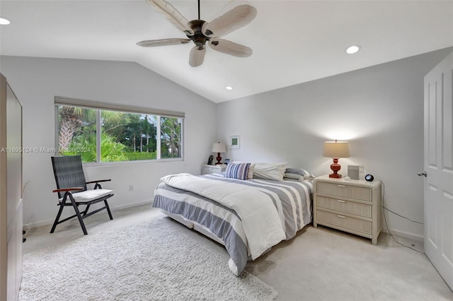 bedroom with ceiling fan, light carpet, and lofted ceiling