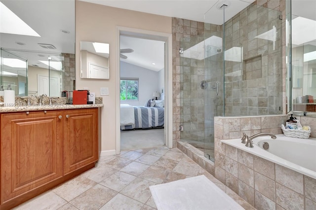 bathroom with vanity, lofted ceiling, and independent shower and bath