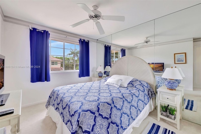 bedroom featuring ceiling fan, ornamental molding, light carpet, and multiple windows