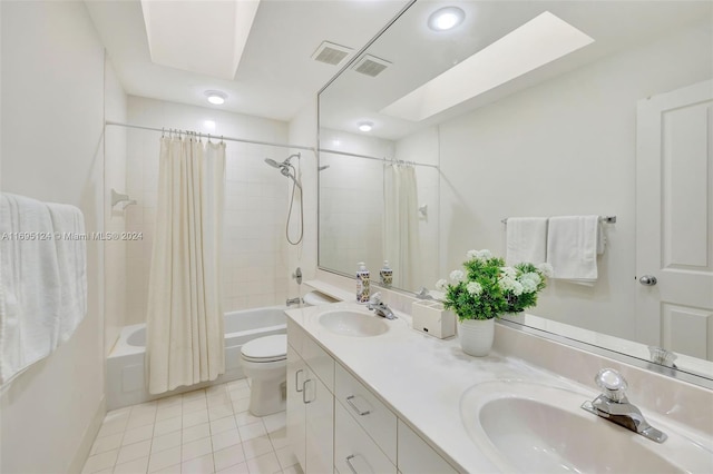 full bathroom with a skylight, toilet, shower / bath combo with shower curtain, and tile patterned flooring