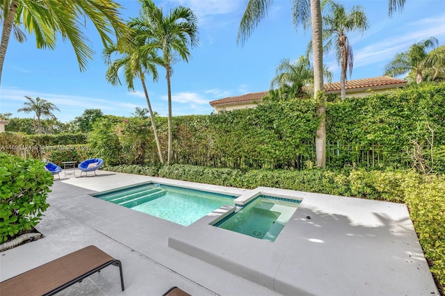 view of pool with an in ground hot tub and a patio