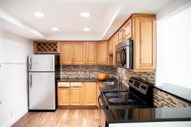 1420 Brickell Bay Dr Unit 1506D, Miami, FL 33131 - kitchen with appliances with stainless steel finishes, tasteful backsplash, light wood-style flooring, recessed lighting, and a tray ceiling