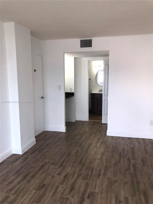1420 Brickell Bay Dr Unit 1506D, Miami, FL 33131 - unfurnished room featuring dark wood-type flooring and a textured ceiling