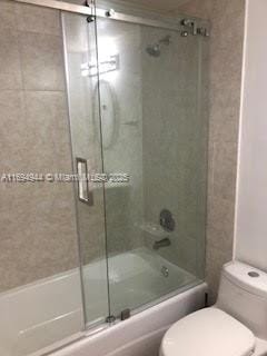 1420 Brickell Bay Dr Unit 1506D, Miami, FL 33131 - bathroom with toilet and enclosed tub / shower combo