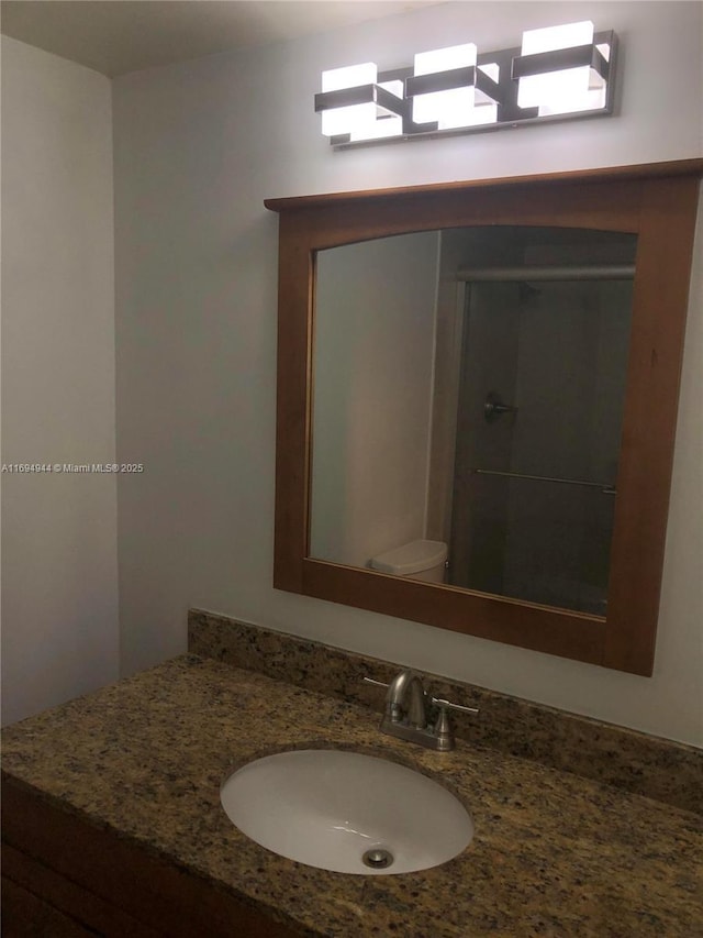 bathroom featuring vanity and toilet