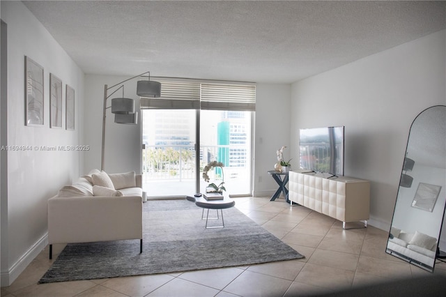 living room featuring a textured ceiling and light tile patterned floors