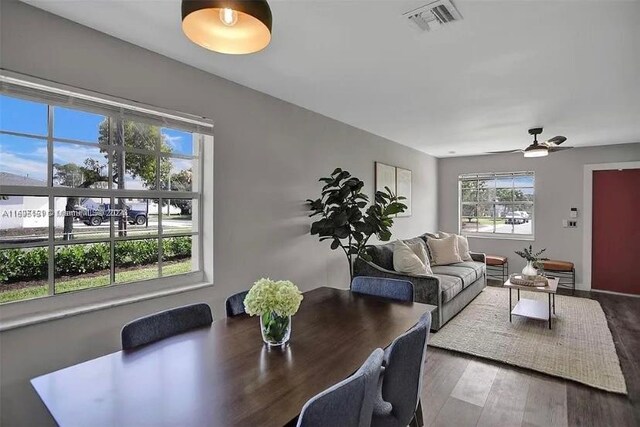 dining space with wood-type flooring and ceiling fan