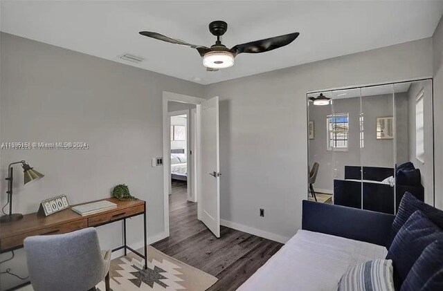 office with wood-type flooring and ceiling fan