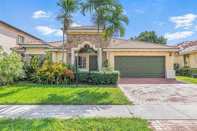 mediterranean / spanish-style house featuring a garage and a front lawn