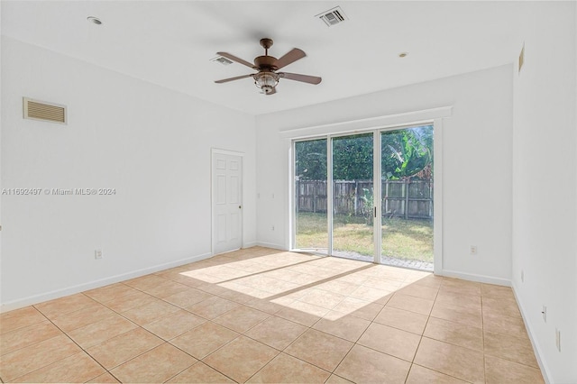 tiled spare room featuring ceiling fan