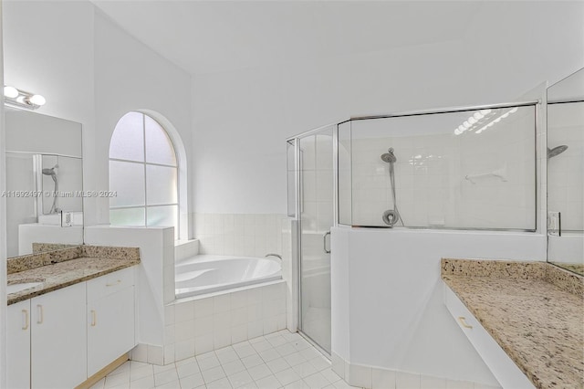 bathroom with tile patterned flooring, shower with separate bathtub, and vanity