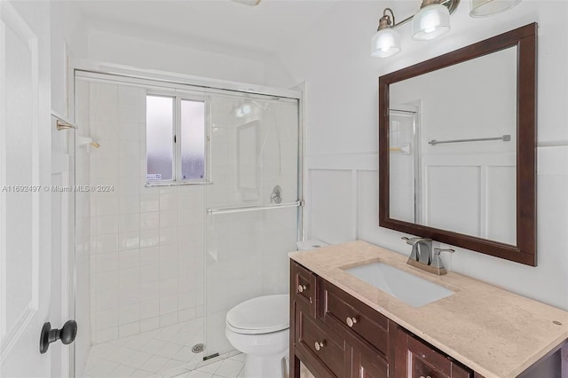 bathroom featuring vanity, an enclosed shower, and toilet