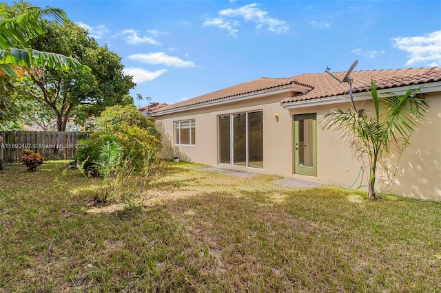 back of house with a lawn