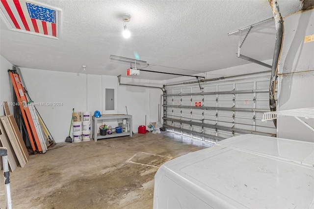 garage with washer / dryer, a garage door opener, and electric panel