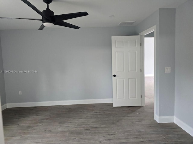 empty room featuring ceiling fan and dark hardwood / wood-style floors