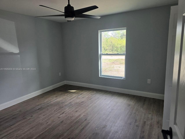 unfurnished room featuring ceiling fan and dark wood-type flooring