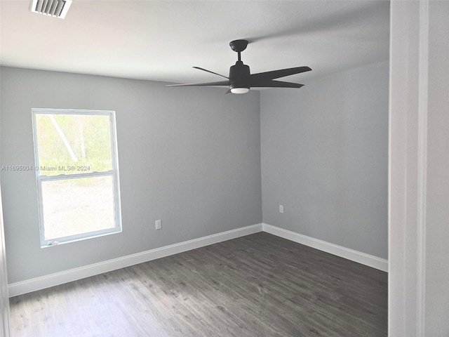 empty room featuring ceiling fan and dark hardwood / wood-style flooring