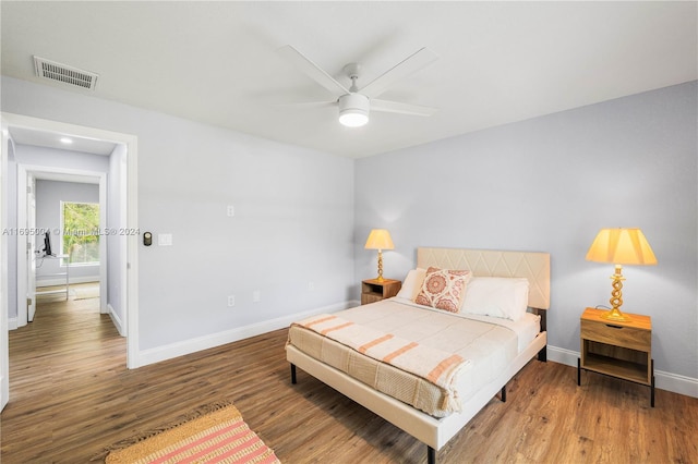 bedroom with ceiling fan and hardwood / wood-style flooring