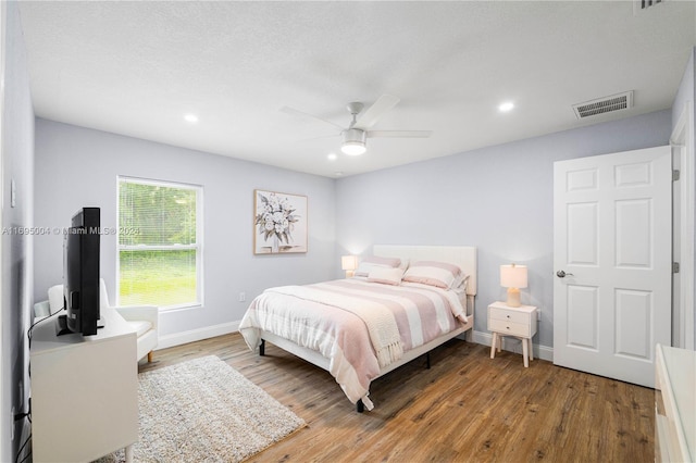 bedroom featuring wood-type flooring and ceiling fan