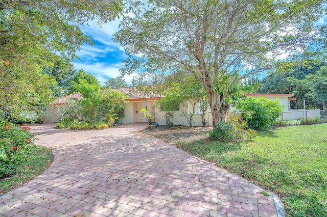 mediterranean / spanish home featuring a front yard