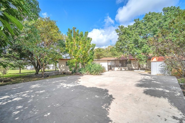 view of front of home with a storage shed