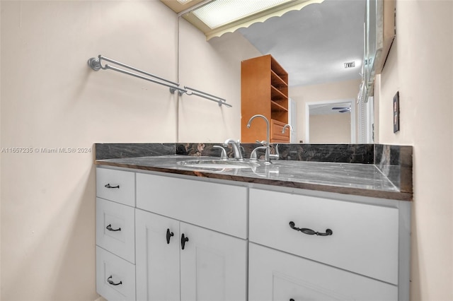 bathroom featuring vanity and a skylight