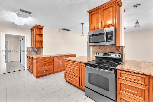 kitchen featuring decorative backsplash, pendant lighting, a textured ceiling, and stainless steel appliances