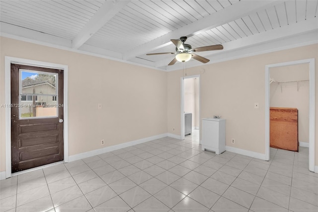 tiled empty room with beam ceiling, ceiling fan, and wood ceiling