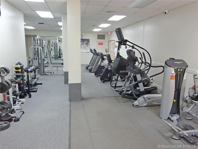 exercise room featuring a drop ceiling