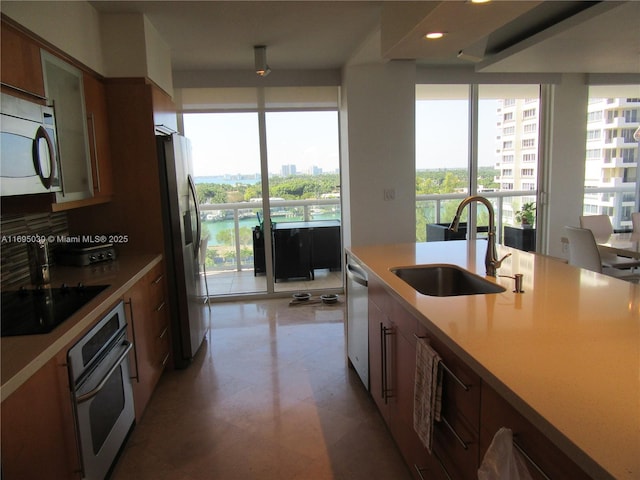 kitchen featuring backsplash, sink, and appliances with stainless steel finishes