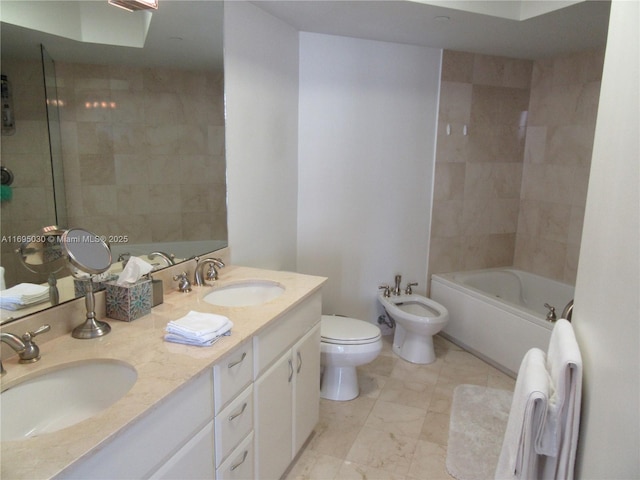 bathroom featuring vanity, toilet, and a bidet