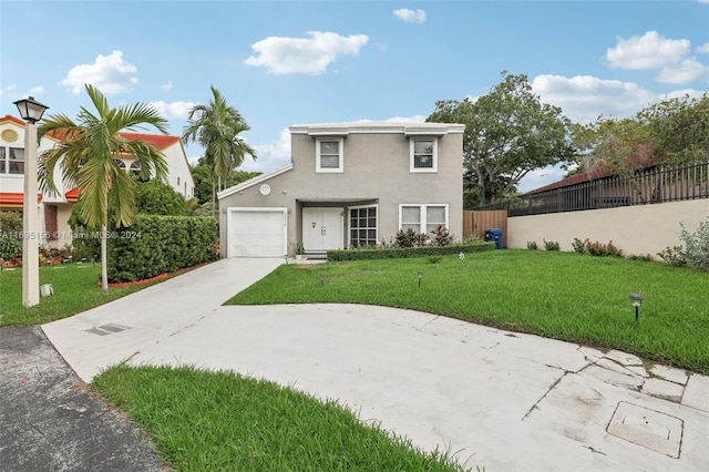 view of front of property featuring a front lawn and a garage