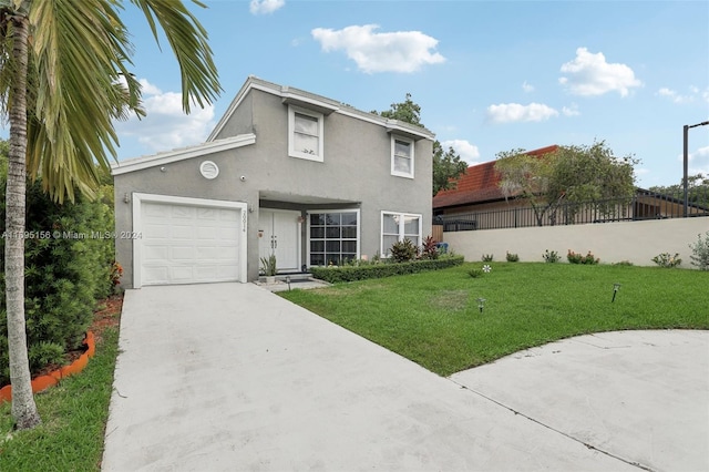 view of front facade with a front yard and a garage