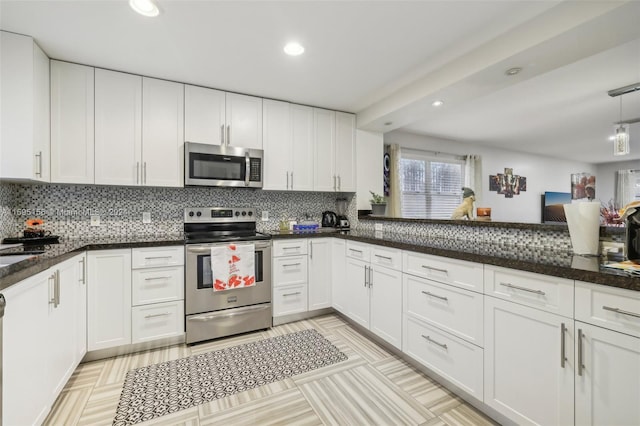 kitchen featuring tasteful backsplash, white cabinets, and stainless steel appliances