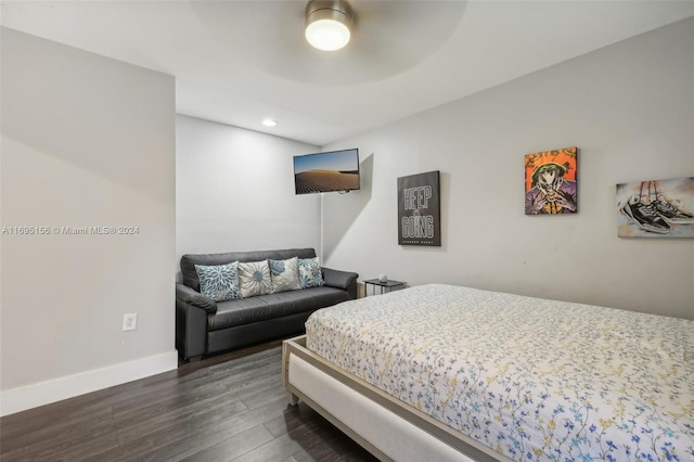 bedroom with dark hardwood / wood-style floors and ceiling fan