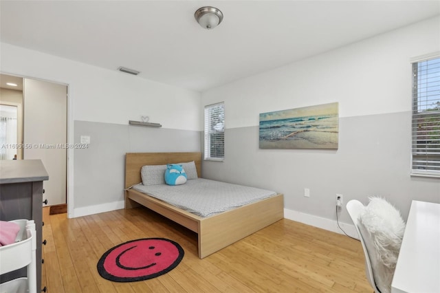 bedroom with hardwood / wood-style flooring